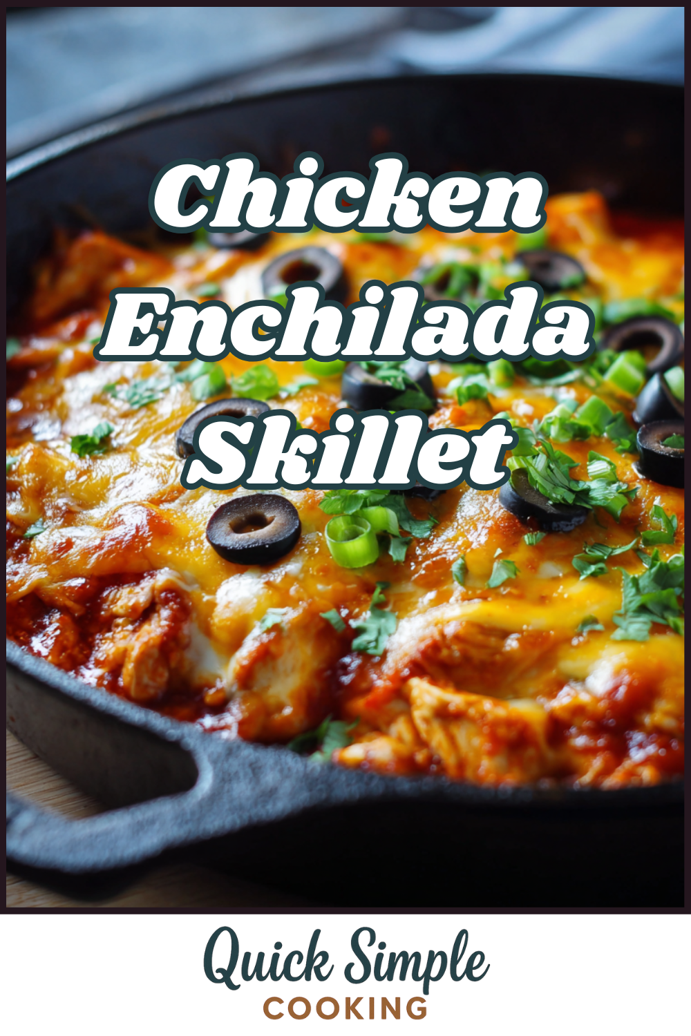 A chicken enchilada skillet topped with melted cheese, sliced black olives, and chopped green herbs in a cast iron pan.